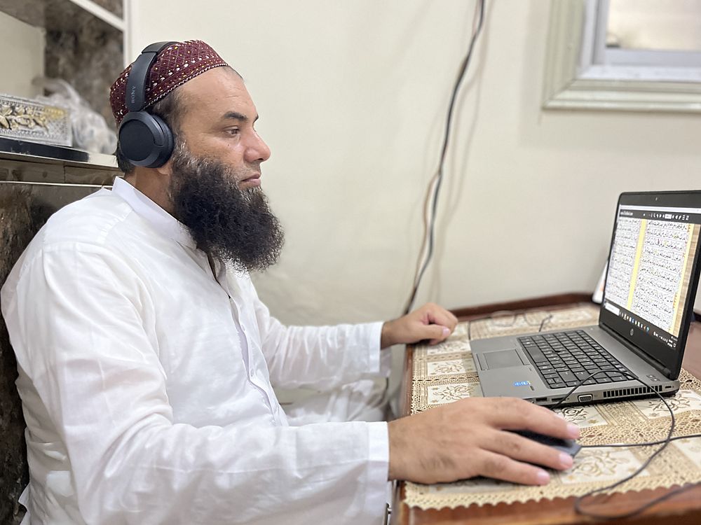 Qari Muhammad Naveed Raja listening to a student during a lesson