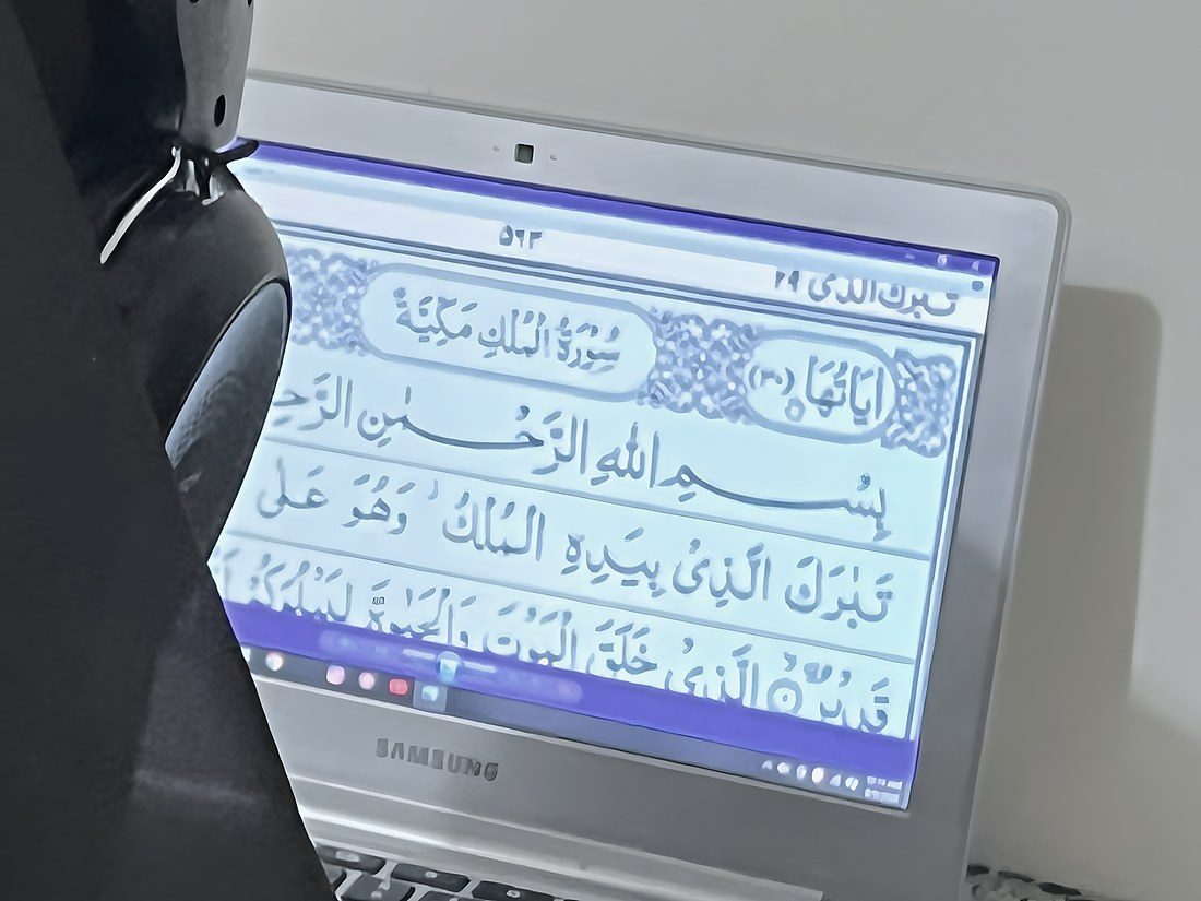 The page of the Quran open on a student’s laptop during her lesson
