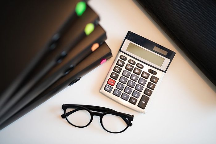 Notebooks and a calculator on a desk, for the mathematics classes